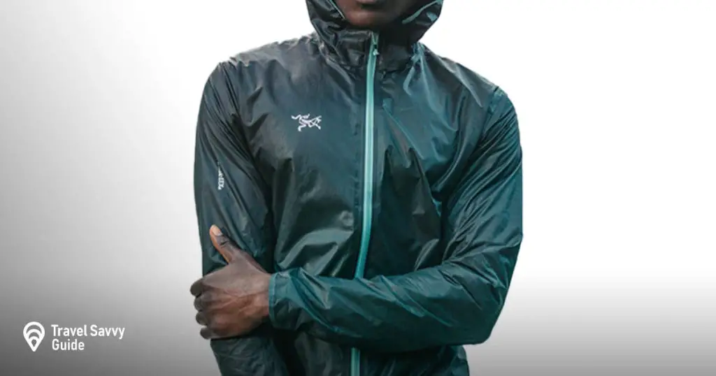 a man wearing a Arc'teryx Norvan SL Hoody rain jacket