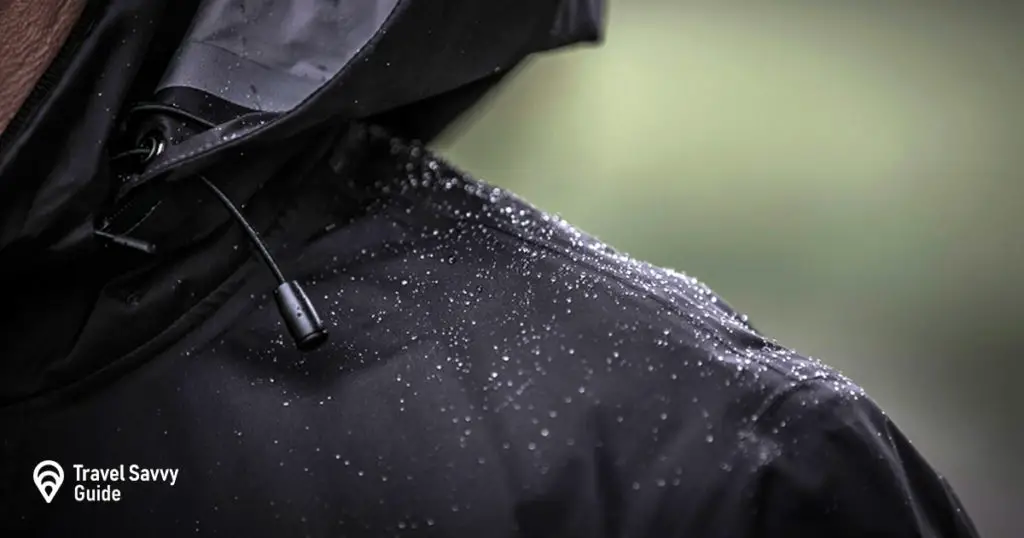 A black rain jacket showing its water repellant properties