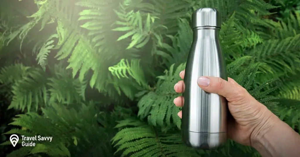 steel flask on a green background