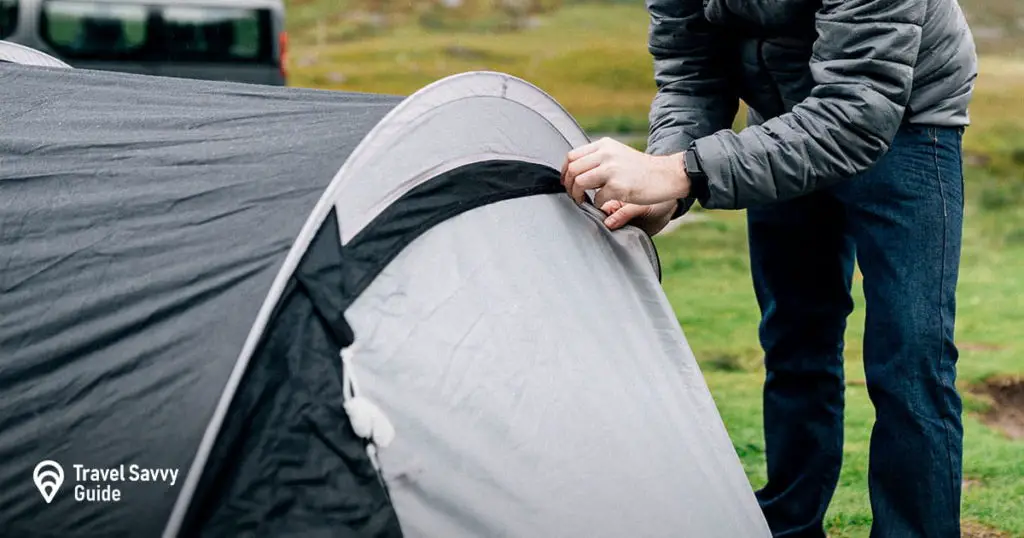 Man trying to unzip a tent