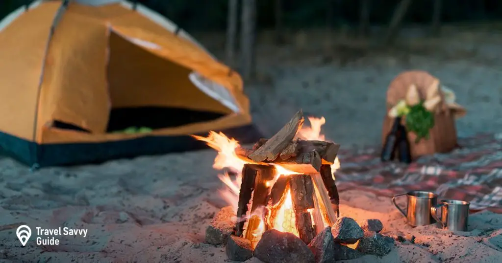 Bonfire on a beach near a tent