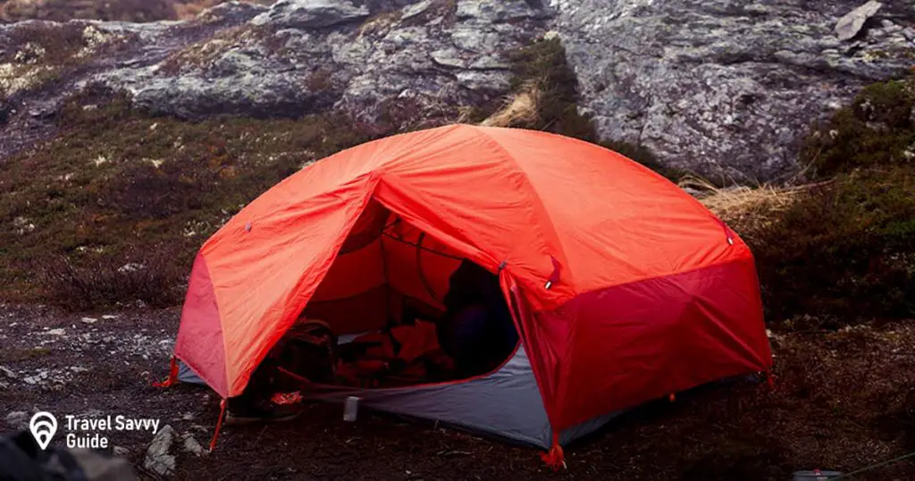 a red tent on a rocky surface