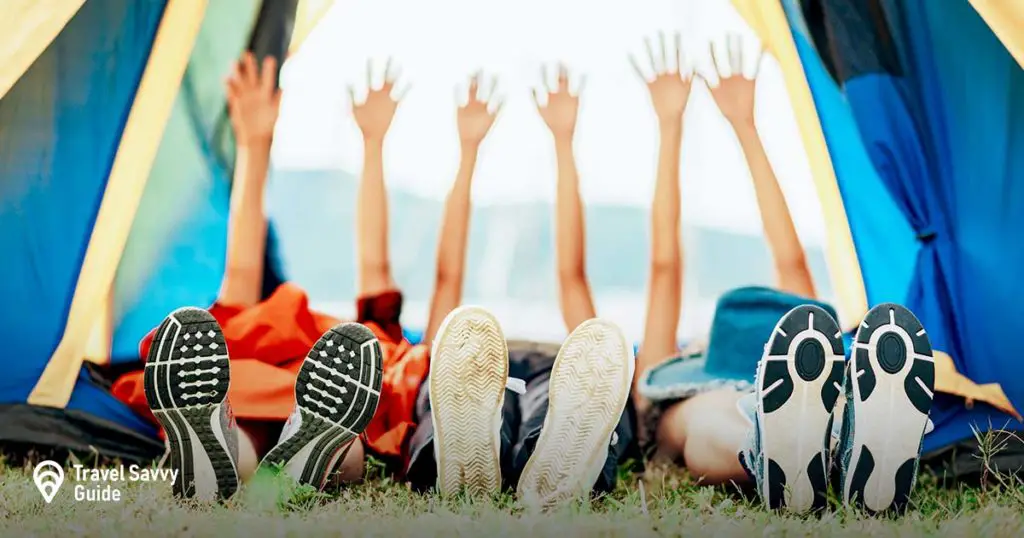 people with their arms up in a tent