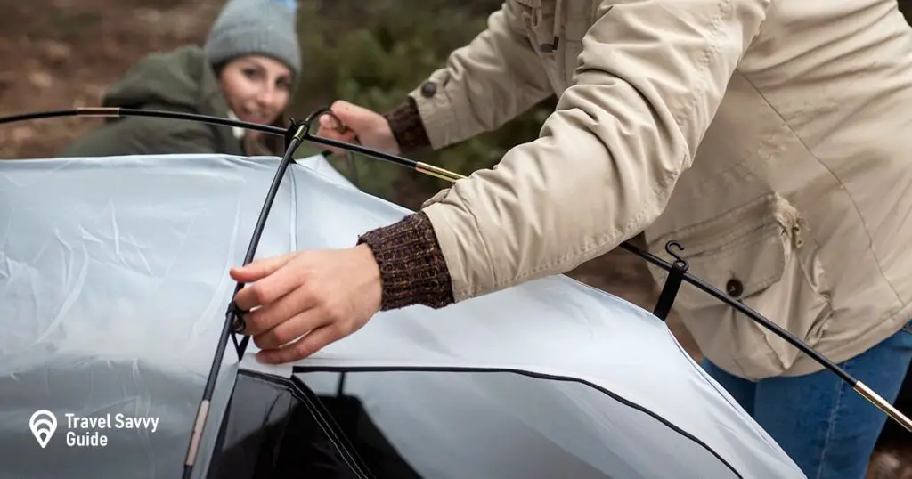 Couple setting up tent together