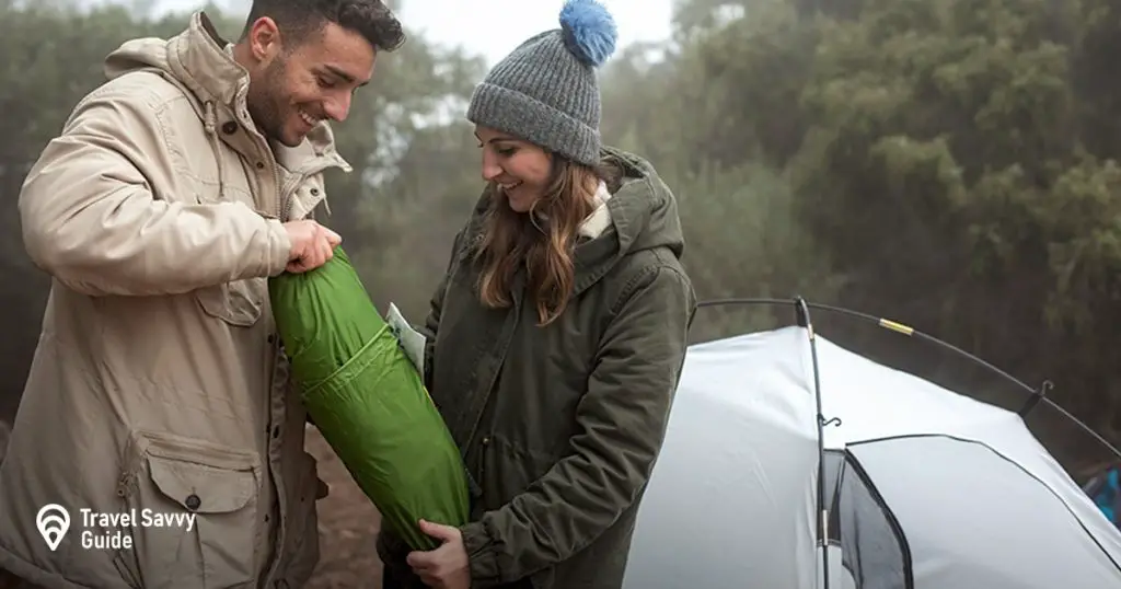 couple putting up a tent 
