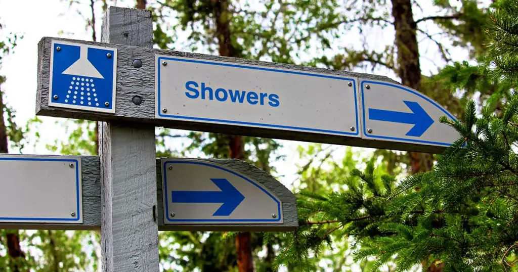 A direction sign for showers at a campground