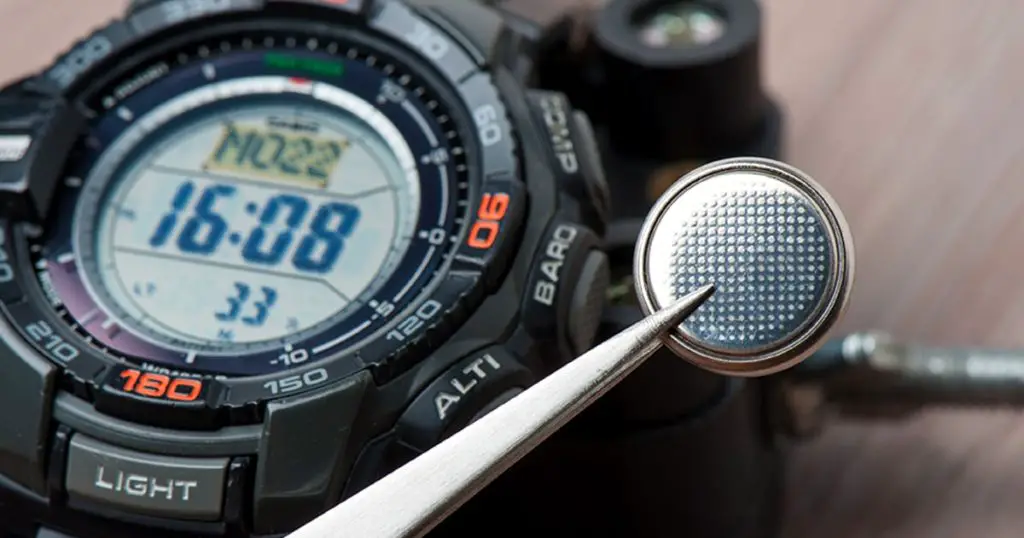 watch battery replacement, watchmaker replacing watch battery on quartz watch