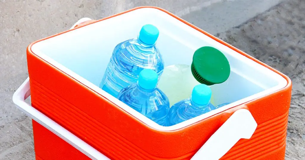 Cool box containing water bottles and juice