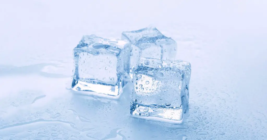 Melted ice cubes close up isolated on white background