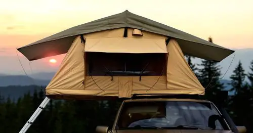 Car camping tent on the rooftop of an SUV in mountains