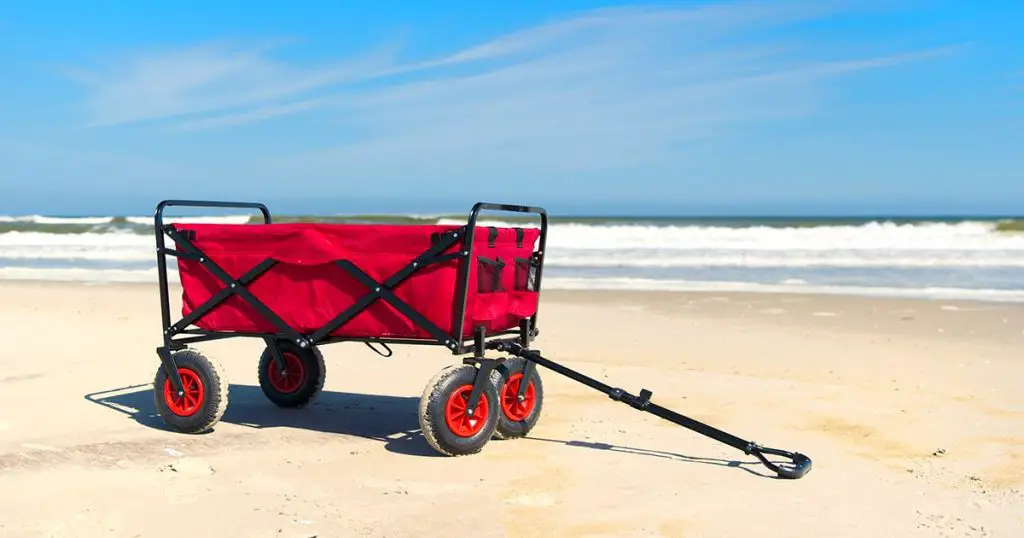 Red beach cart standing in front of sea