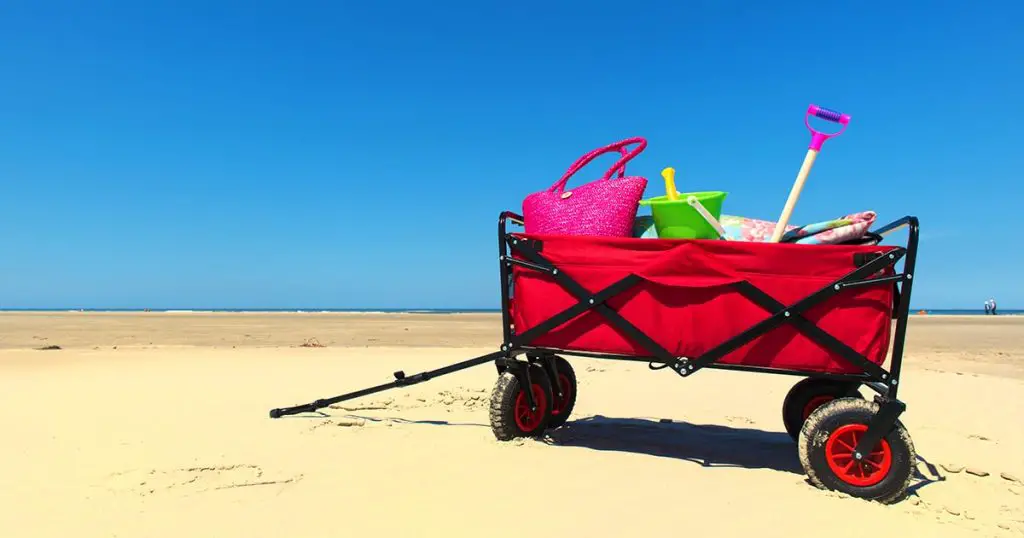 Hand cart with vacation luggage at the beach