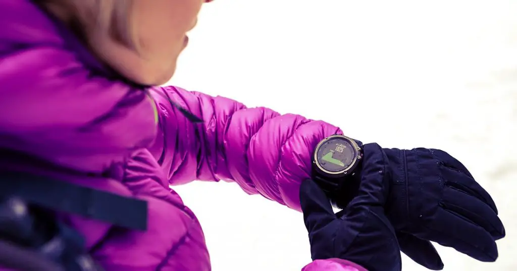 Woman hiker checking the elevation on sports watch