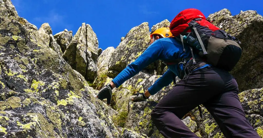 Climbing a mountain wearing gloves