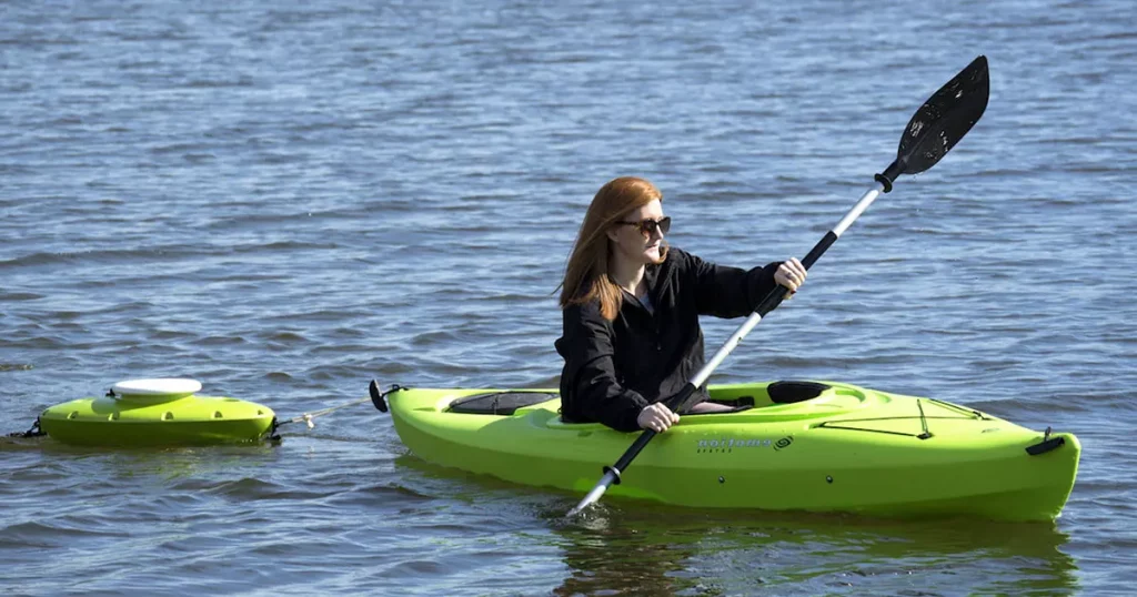 Woman kayaking with a Floating Cooler