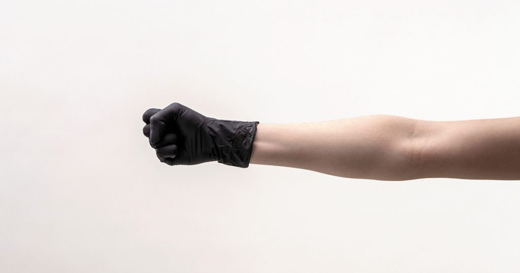 female hand in a black silicone glove