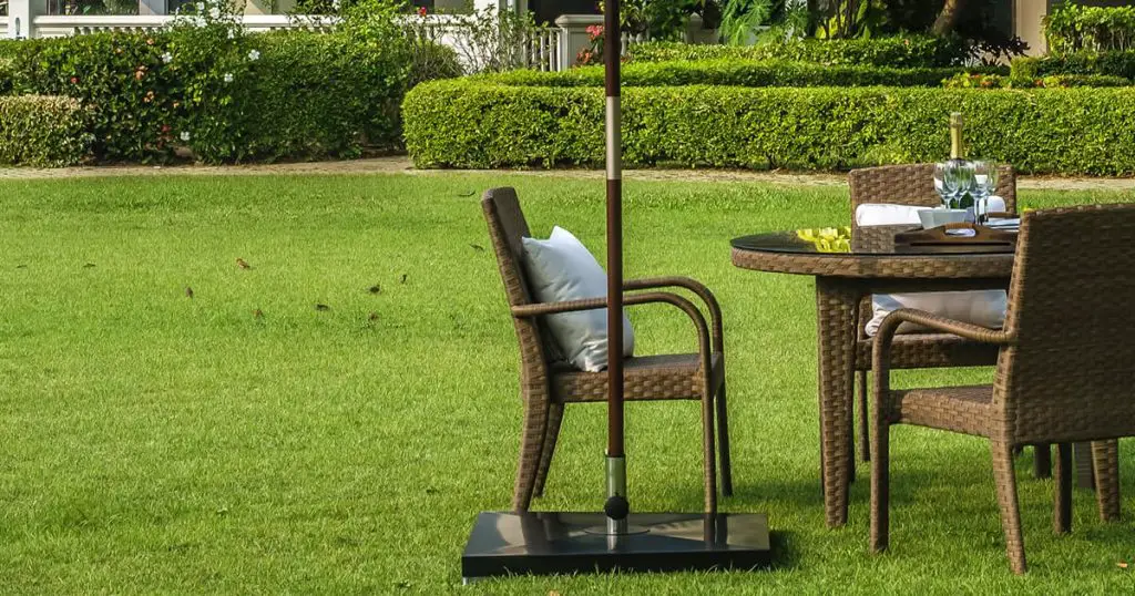Rattan furniture, table, chairs, umbrella and outdoor pillows