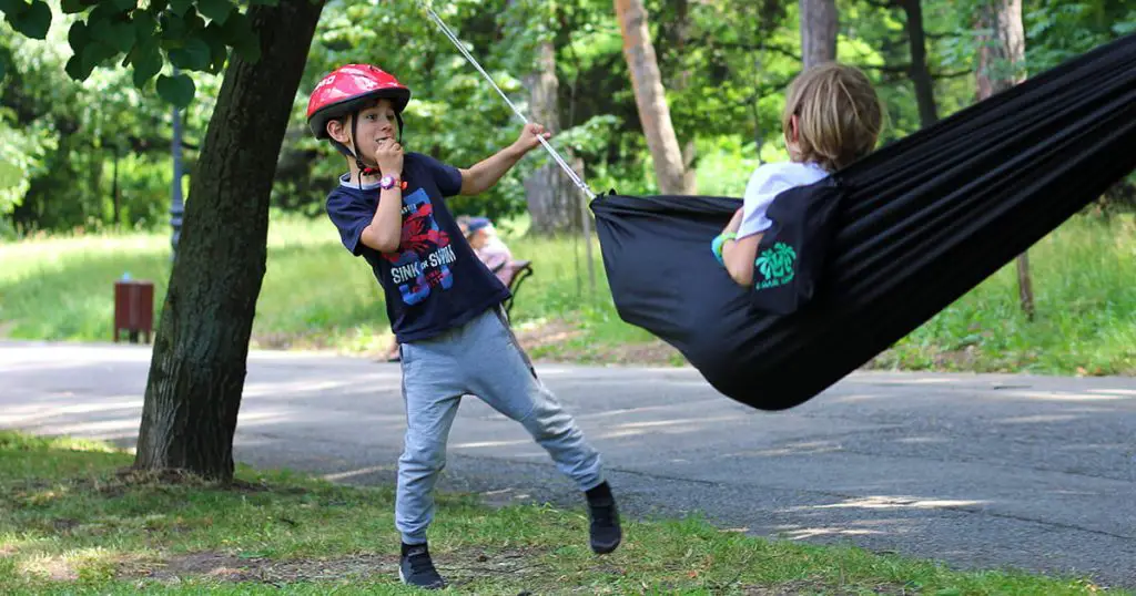 Two boys playing with the hammock