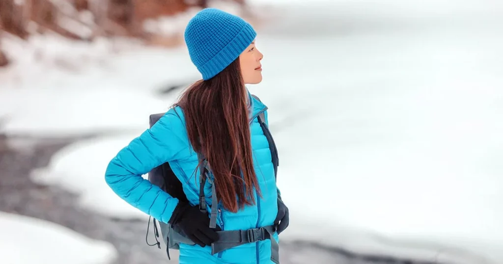 woman hiker walking on snow hike trail