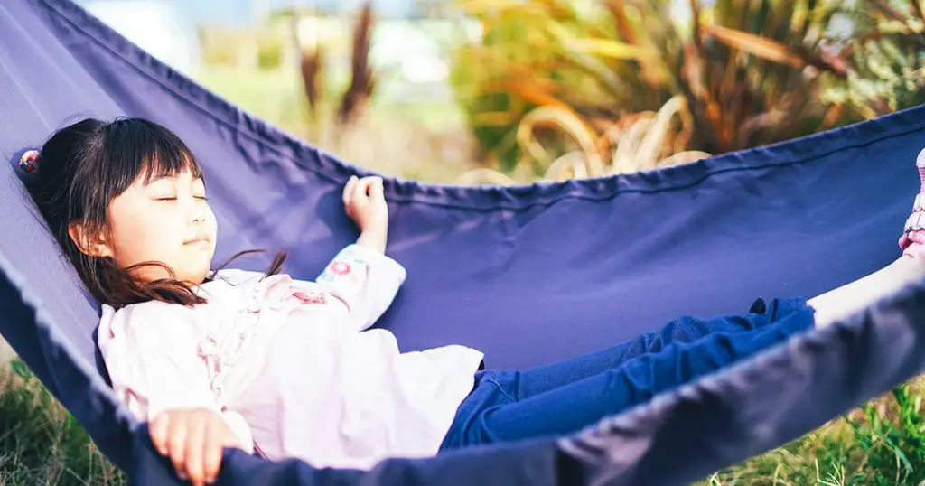 Little girl enjoying camping with smile