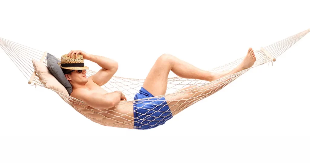 Shirtless young guy lying in a hammock and sleeping isolated on white background