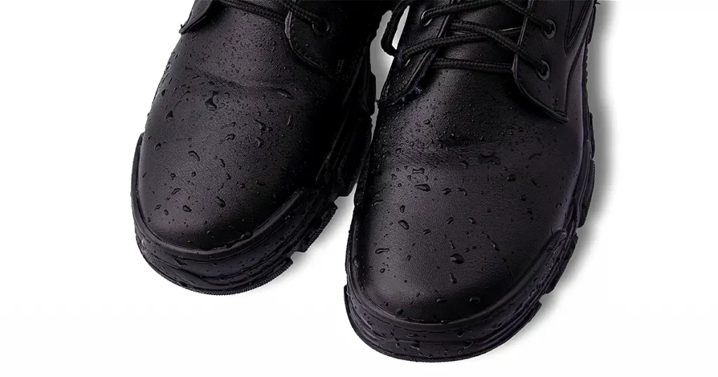 Drops of water on black leather shoes