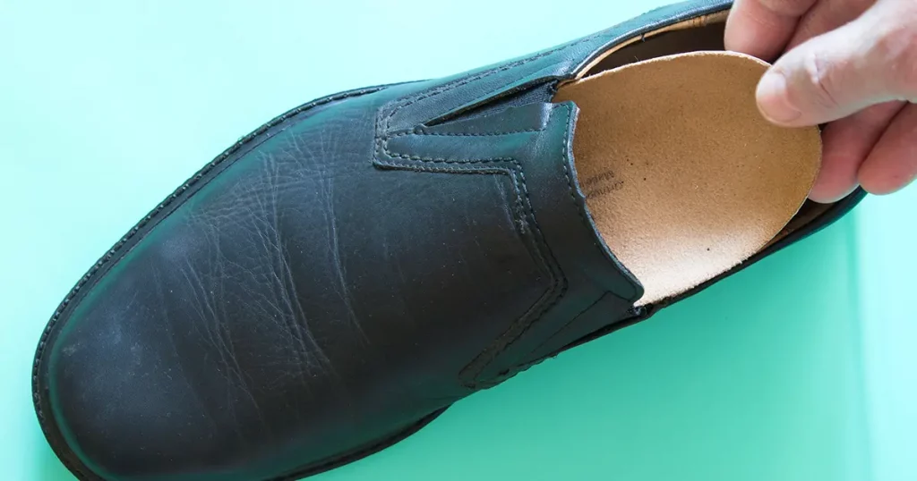 Top view of black leather shoes with orthopedic insoles.
