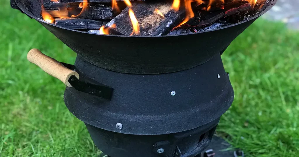 Garden fire in a cast iron fire pit on a spring evening