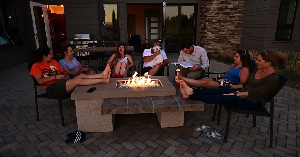 Family and friends enjoy afternoon around fire pit
