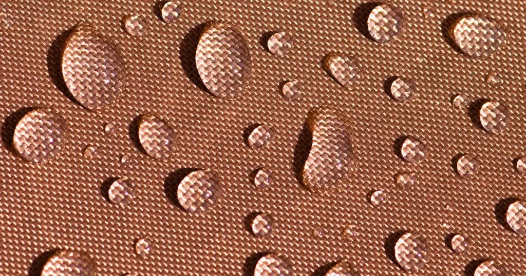 Drops of water on waterproof tent fabric.