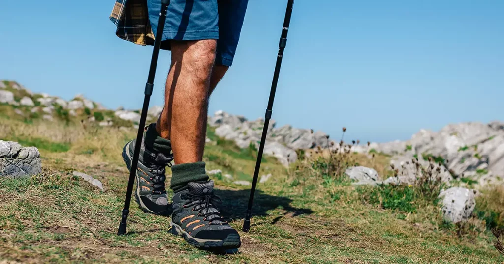 Unrecognizable senior man practicing trekking outdoors