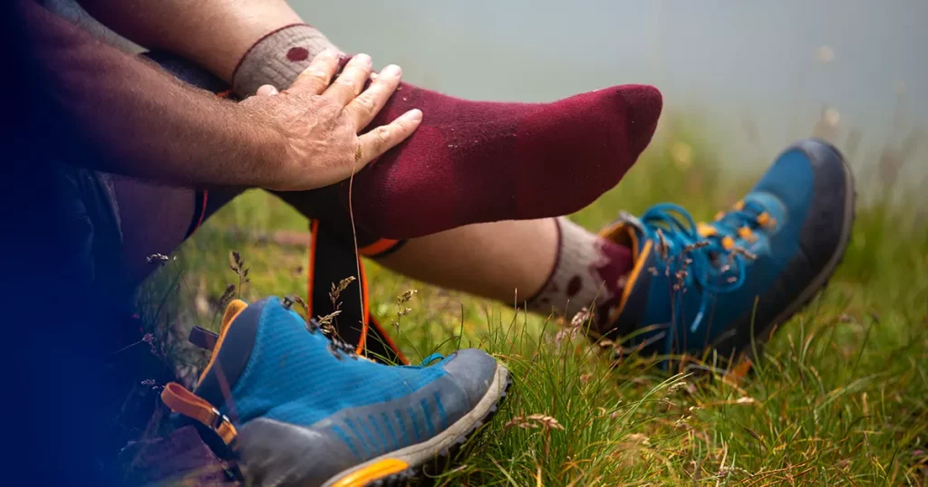 Close up of hiker's feet in socks without shoes resting on mountain peak