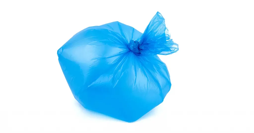 transparent blue plastic garbage bag inflated and tied in a knot, bag isolated on a white background