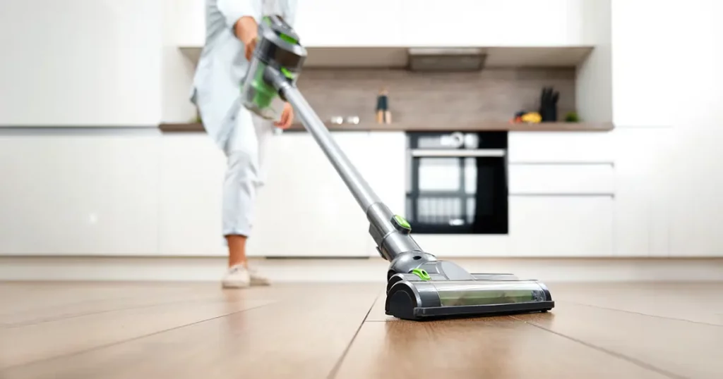 A Young Woman Vacuuming the Floor. Cleaning in the House