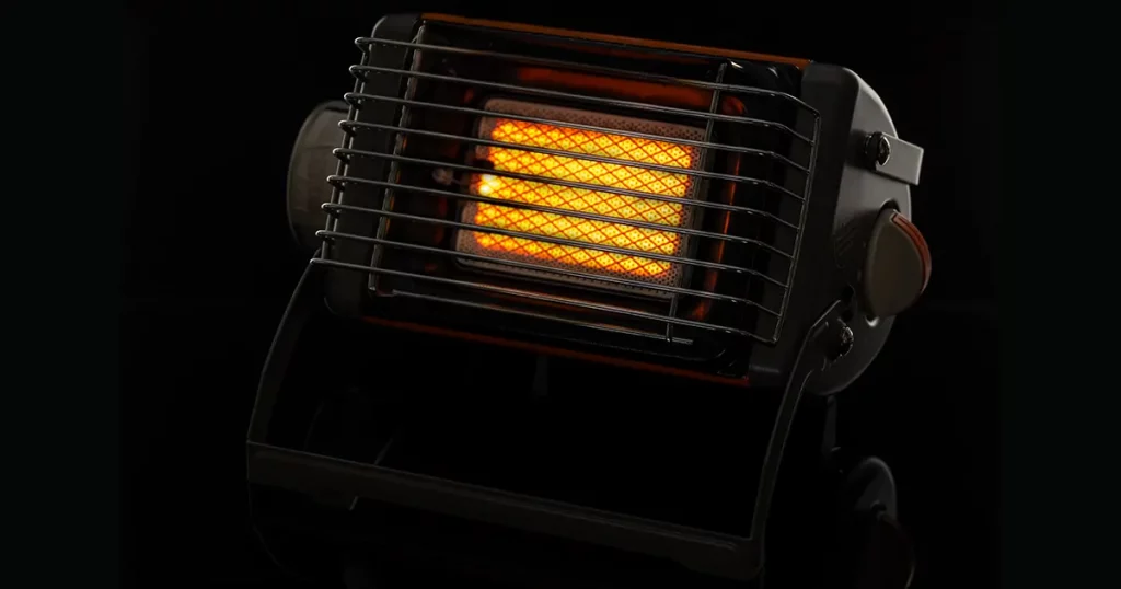 Camping portable gas ceramic heater, works and stands on a black glossy background