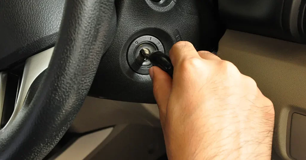 hand-putting-car-key-keyhole-starting