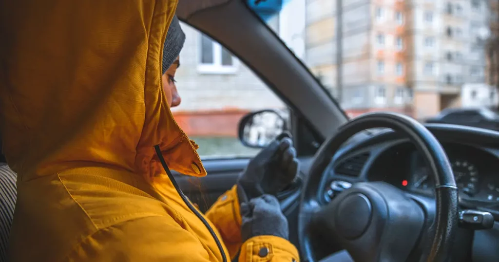 woman drive car in cold winter weather