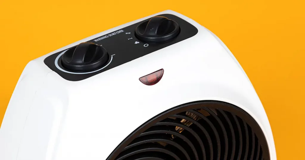 Close up of portable electric heater. Yellow background