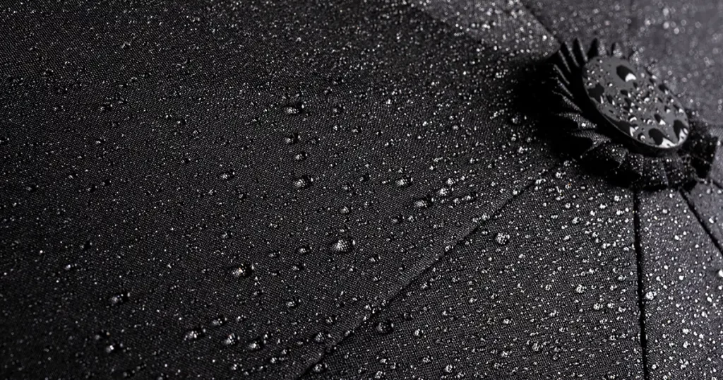 Black waterproof umbrella with water droplets