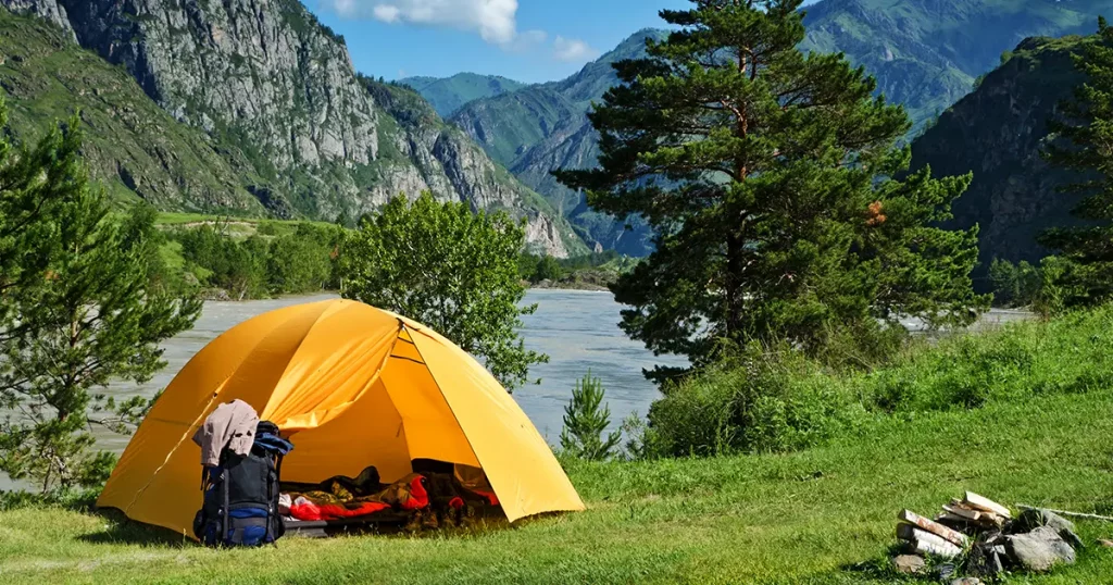 camping-tent-near-mountain-river-summer