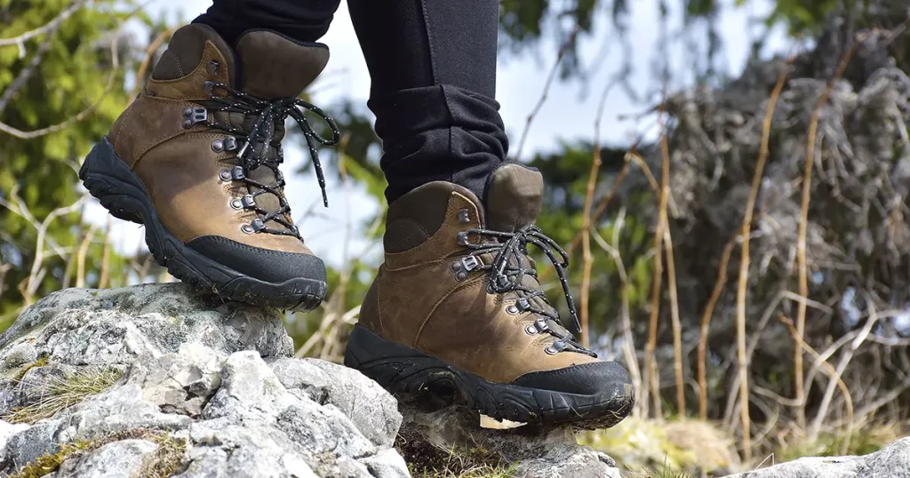 hiking boots on the rock in the mountains. All terrain shoes