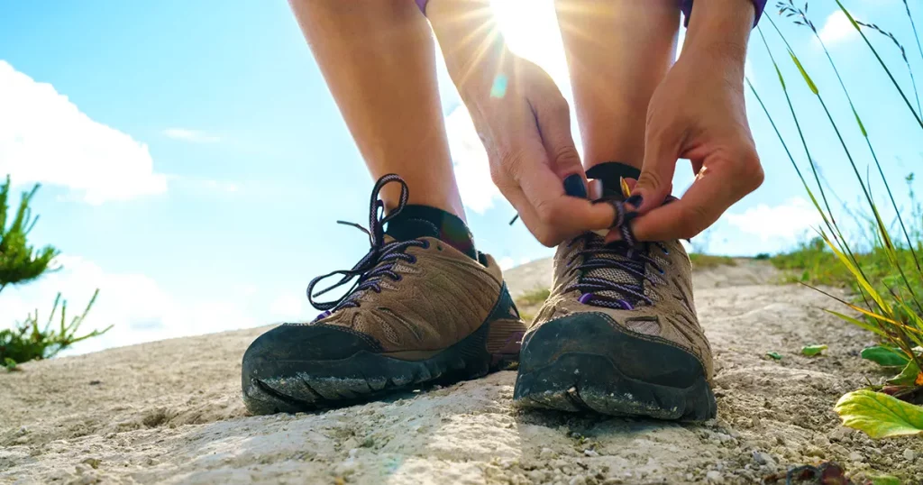 Closeup of female tourist getting ready for hiking