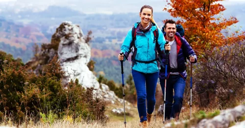 couple-backpackers-hiking-on-path