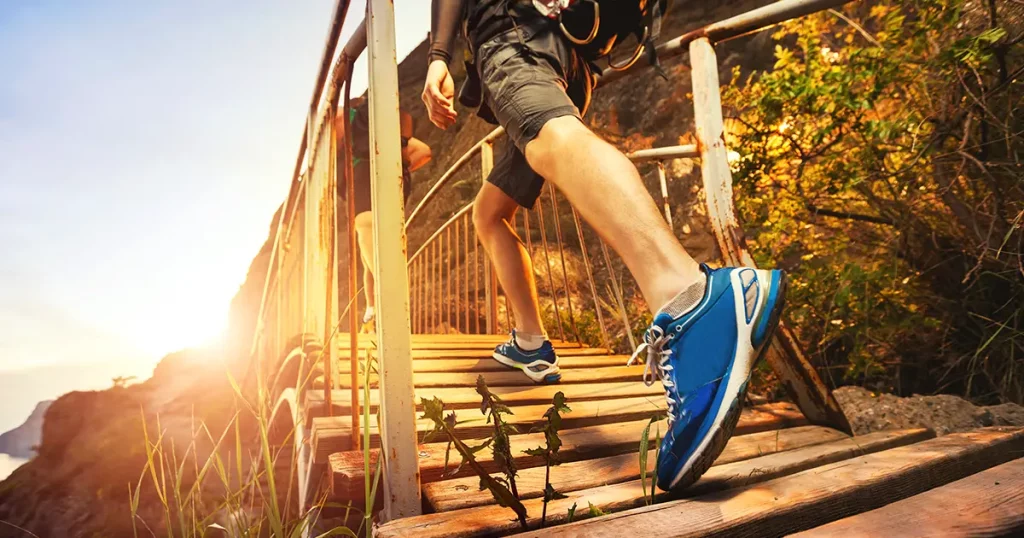 men-hiking-mountains-walking-on-wooden