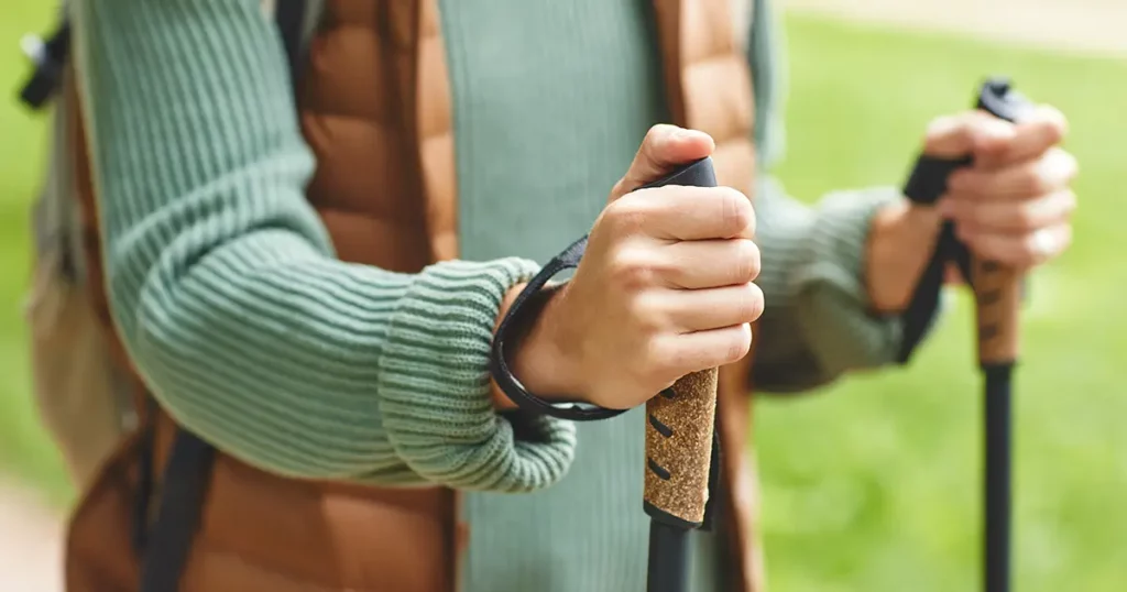 Close-up of woman holding sticks and walking on fresh air