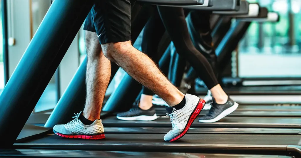 people doing sport on treadmill in gym for healthy life