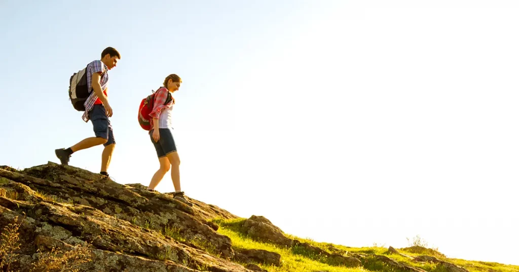 couple-young-happy-travelers-hiking-backpacks