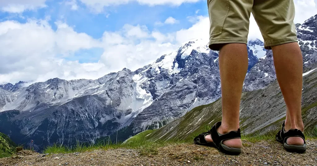 Male hiker standing at the top of the mountain