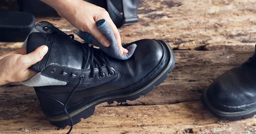 Cleaning shoes on wooden background