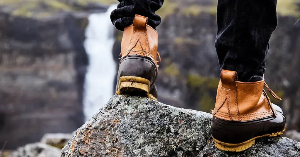 A young man in boots walking around Iceland. close up.